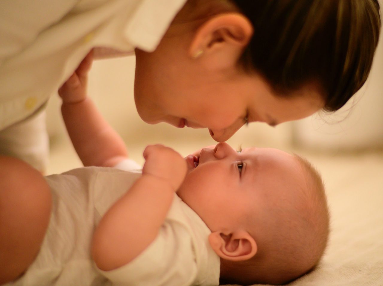 mom touches noses with baby