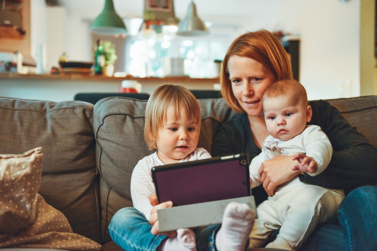 Mom with babies on tablet