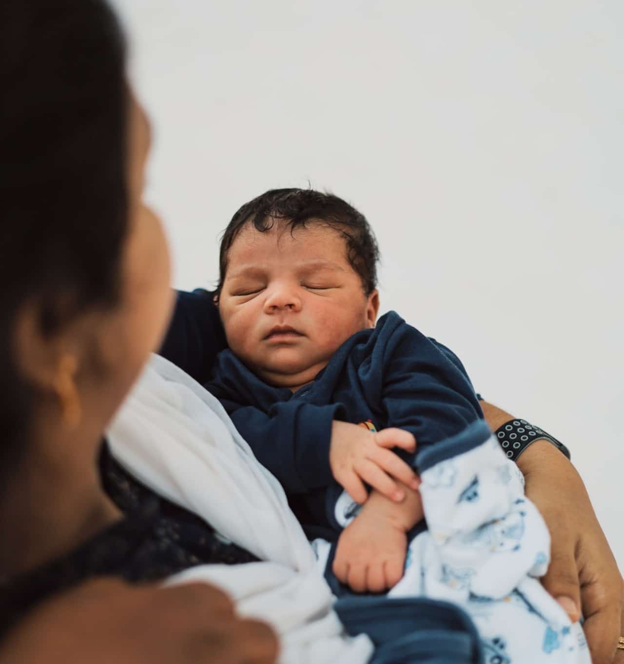 holding newborn