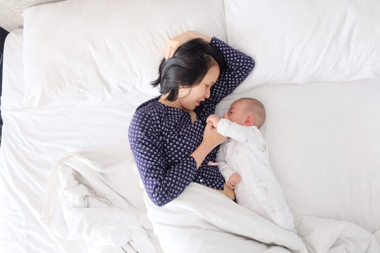 Mom and baby in bed in the morning