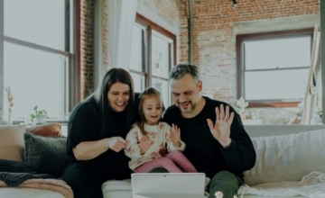 parents and child say hi on tablet