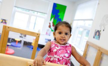 Toddler with furrowed eyebrows in playroom