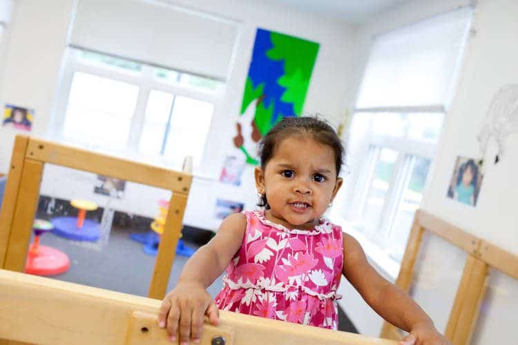 Toddler with furrowed eyebrows in playroom