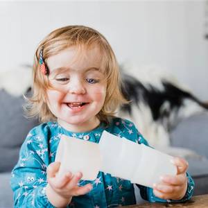 Toddler girl playing with plastic container