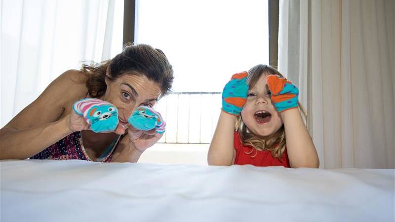 Mother and daughter playing with socks