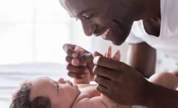 Dad playing with baby on back