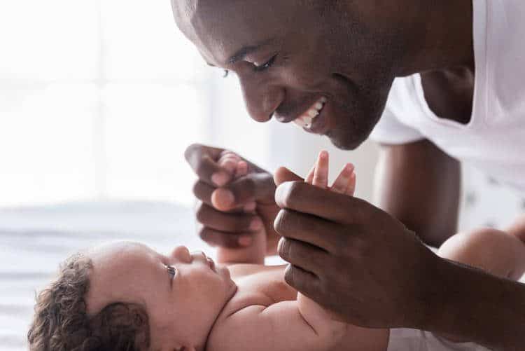 Dad playing with baby on back