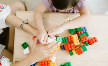 Child playing with wooden toys