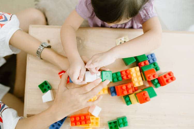 Child playing with wooden toys