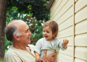 Man carrying child both smiling