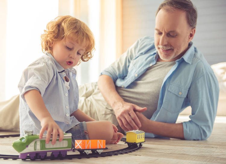 Dad and boy playing with train toy