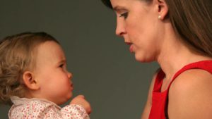 Woman looking at infant 