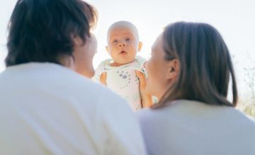 Couple holding up an infant