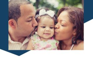 Man and woman kissing an infant one on each cheek