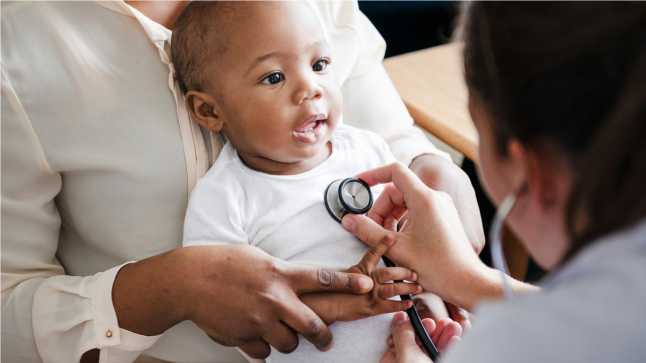 baby being checked by stethoscope