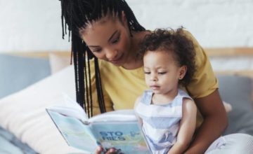 Mother reading a book to their toddler