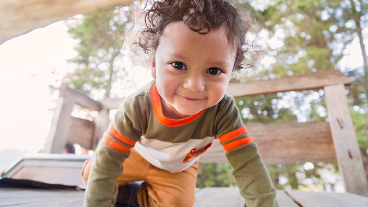 Toddler smiling and crawling