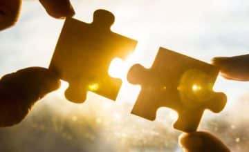 Hands holding puzzle pieces