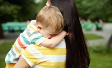 woman holding child in arms