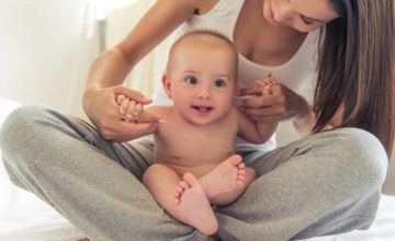 Mother Playing with Baby in Lap