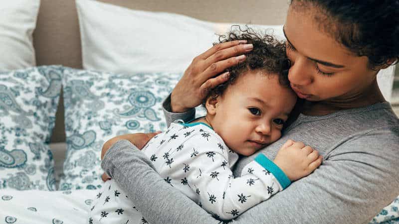 Mother holding baby on her chest