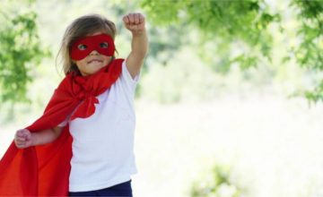 Toddler girl dressed in superhero costume