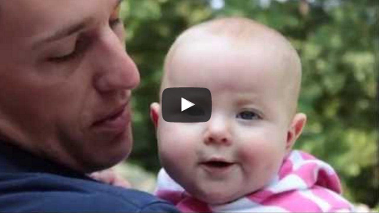video still father holds baby looking at camera