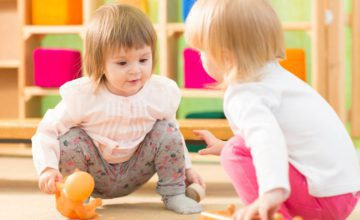 two young toddlers playing in classroom