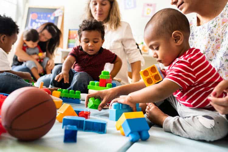 Parents with their toddlers playing with toys