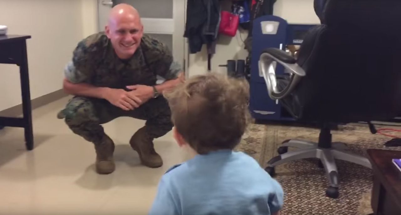 military father greets young son