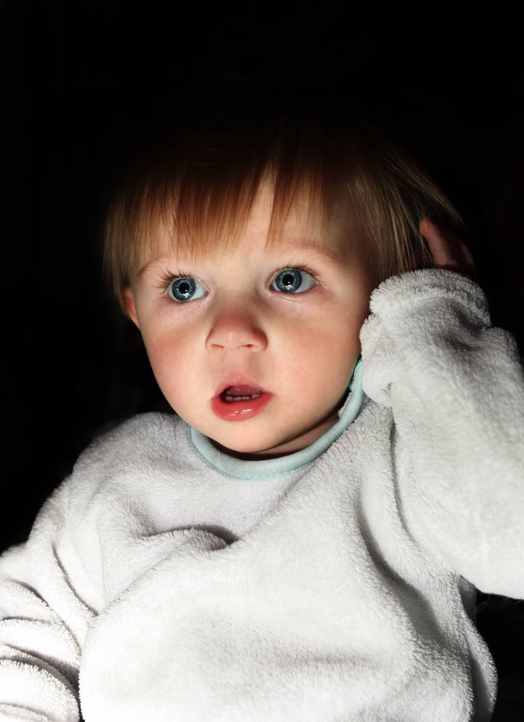 photo of frightened 2 year old in the dark