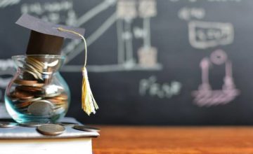 Coins in a jar with a graduation cap