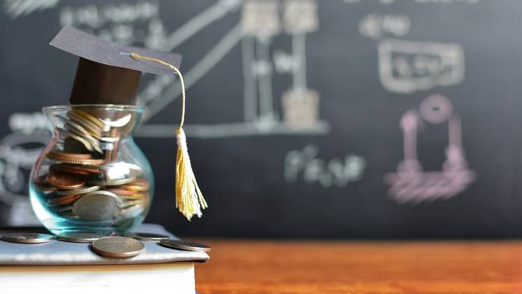 Coins in a jar with a graduation cap