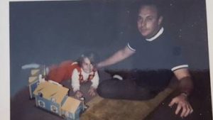 father sitting on floor with child