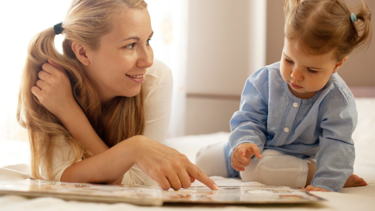 woman reading with child on floor