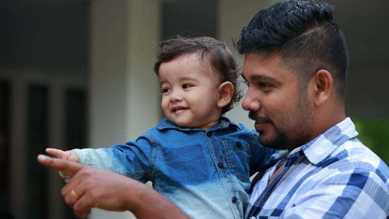 Father and Son Pointing Together