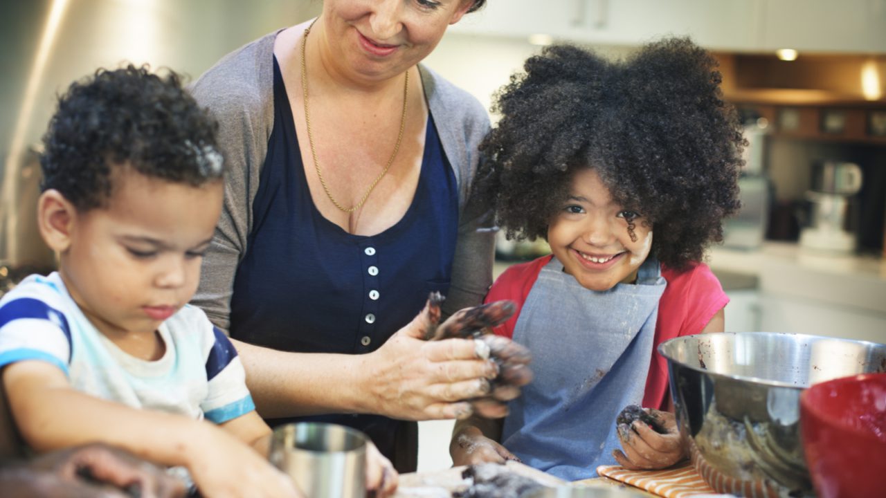 woman and children at table cooking