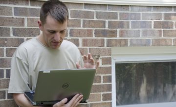 father talking to someone on the computer via video call