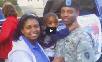 video still of family with father in military uniform holding child and wife smiling