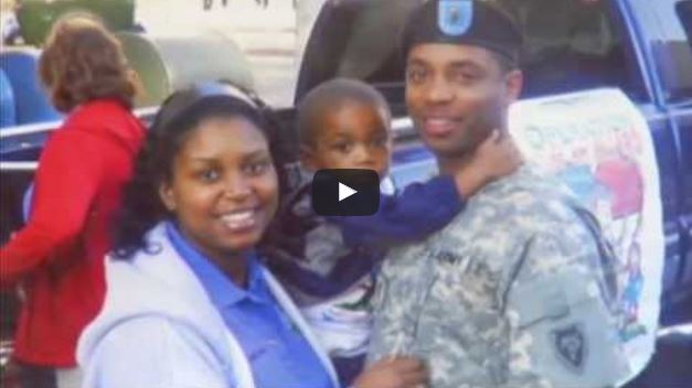 video still of family with father in military uniform holding child and wife smiling