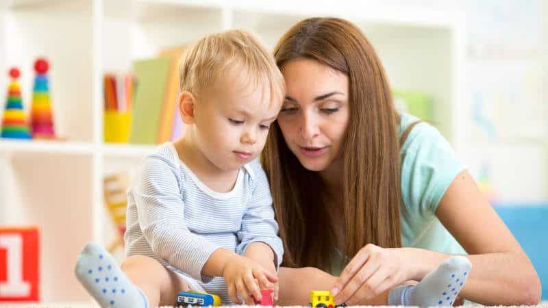 Caregiver and young child playing together