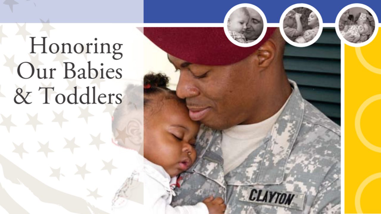 father in military uniform holds daughter in arms sleeping while he looks down smiling