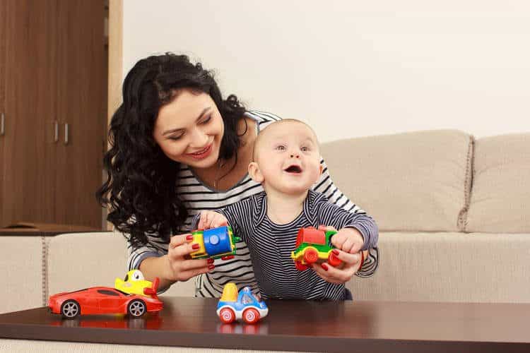 Mother and baby playing with toys