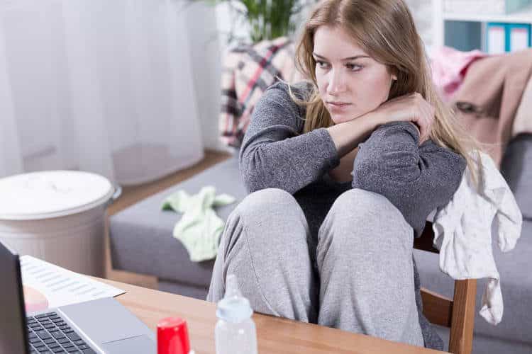 Mother sitting at a desk with computer