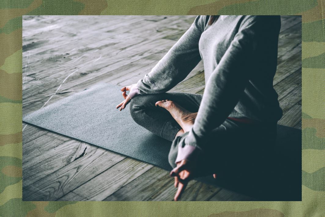 woman sitting in meditation pose with fingers touching