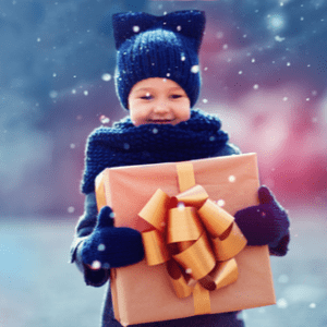 A young child clutches a wrapped gift while walking in the snow.