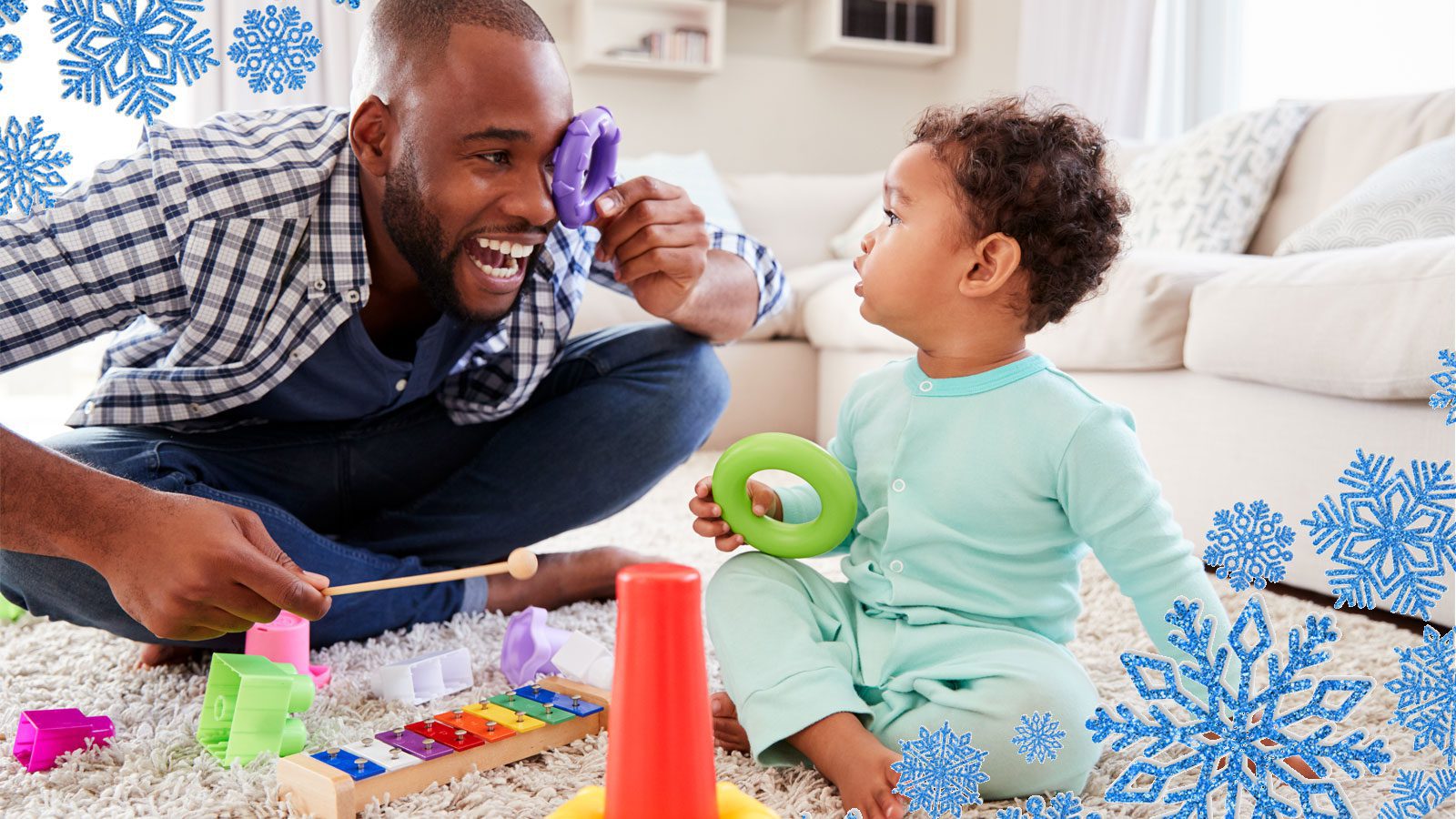 A father plays with his toddler and their toys.