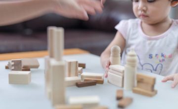 Baby playing with wooden blocks