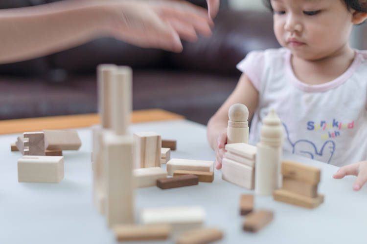 Baby playing with wooden blocks