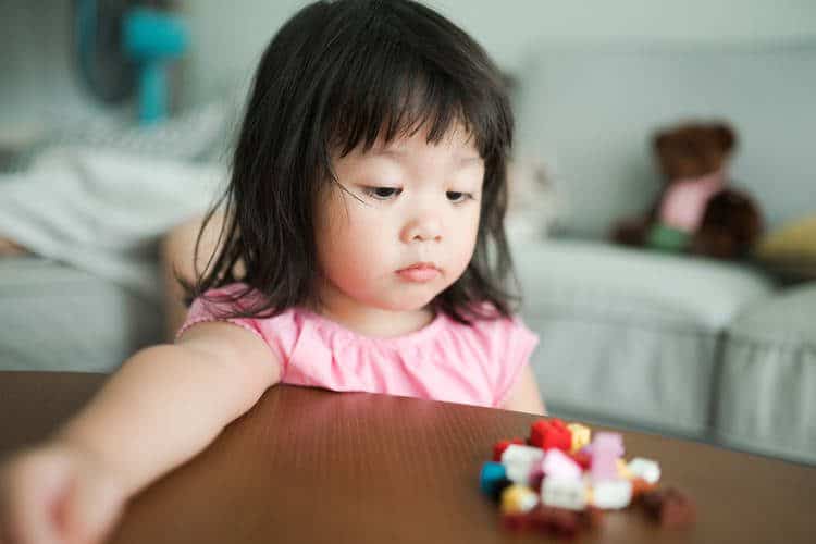 Asian girl looking at blocks